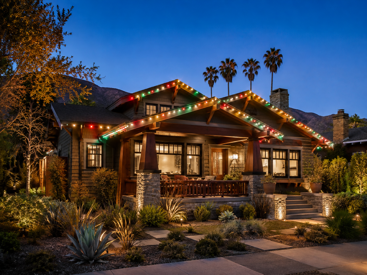 Craftsman bungalow in Los Angeles outlined with permanent holiday lighting at night